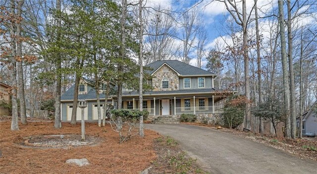 view of front of house featuring a porch and a garage