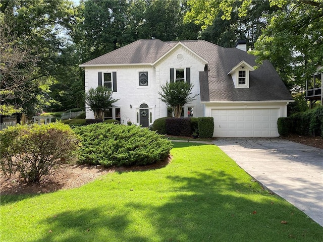 5440 Cameron Forest Pkwy, Johns Creek, GA 30022 - view of front of house with driveway, a chimney, a front lawn, a shingled roof, and an attached garage