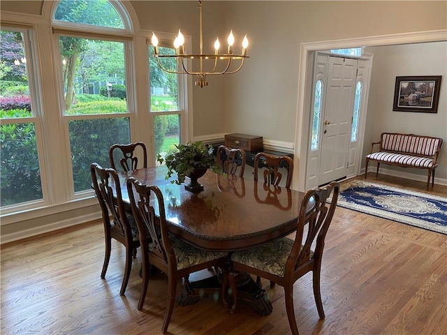 5440 Cameron Forest Pkwy, Johns Creek, GA 30022 - dining area with a chandelier and light wood-type flooring