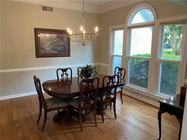 5440 Cameron Forest Pkwy, Johns Creek, GA 30022 - dining space with a chandelier, light wood-style floors, and crown molding