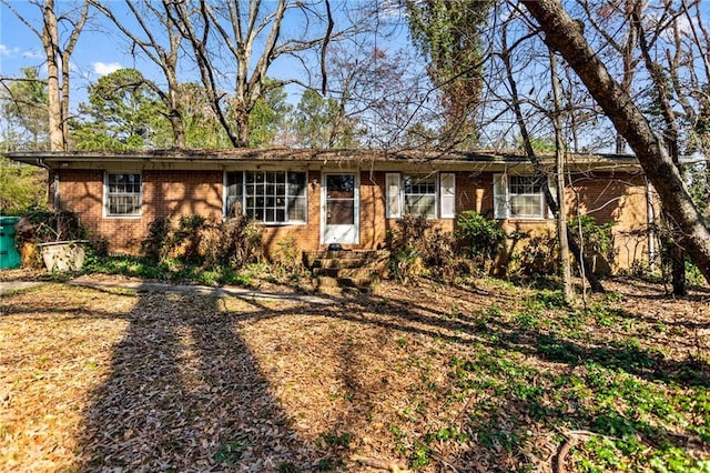 ranch-style house featuring brick siding