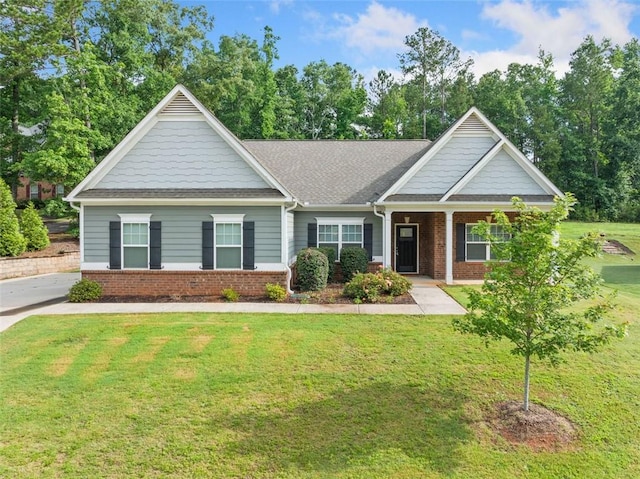 110 Collingwood Lndg, Covington, GA 30016 - view of front of house with brick siding, a front yard, covered porch, and a shingled roof