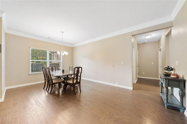 110 Collingwood Lndg, Covington, GA 30016 - dining room with dark wood-style floors, a chandelier, and crown molding