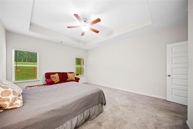 110 Collingwood Lndg, Covington, GA 30016 - carpeted bedroom featuring a tray ceiling and a ceiling fan