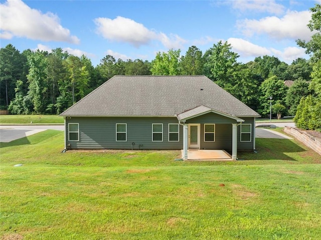 110 Collingwood Lndg, Covington, GA 30016 - rear view of property with a lawn, a patio, and roof with shingles