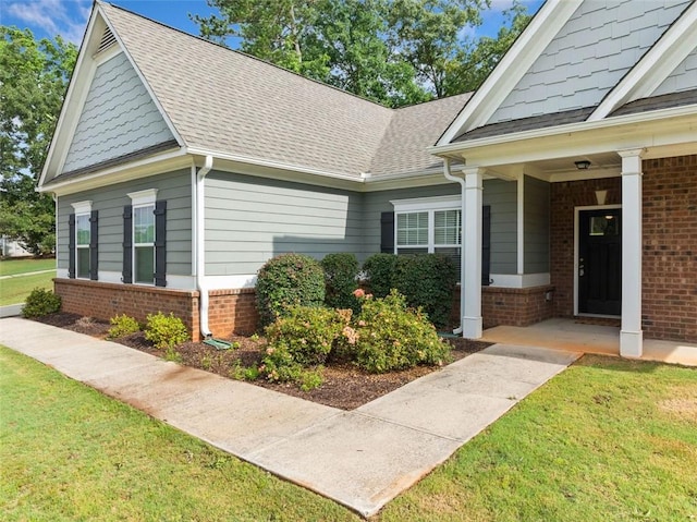 110 Collingwood Lndg, Covington, GA 30016 - view of side of property featuring brick siding, a yard, and a shingled roof