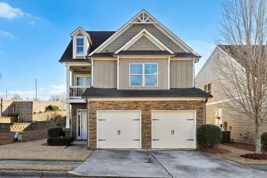 craftsman-style home featuring a garage and a balcony