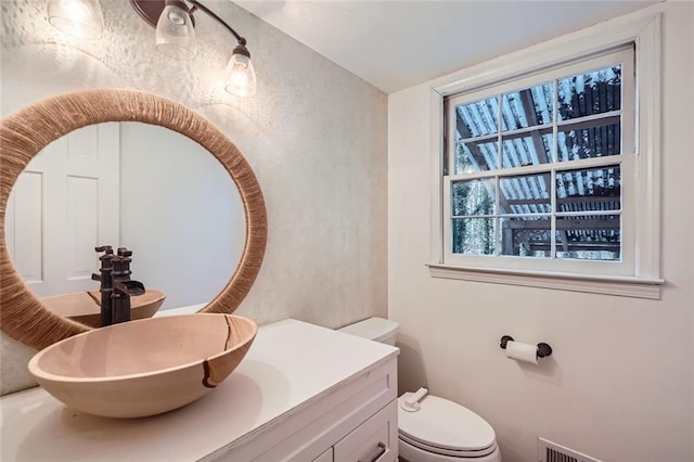 bathroom featuring vanity and toilet