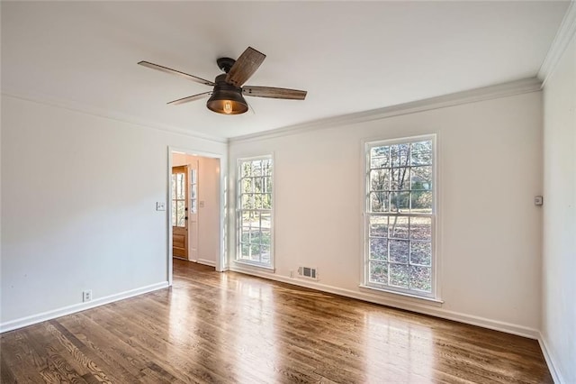 spare room featuring ceiling fan, ornamental molding, and dark wood-type flooring