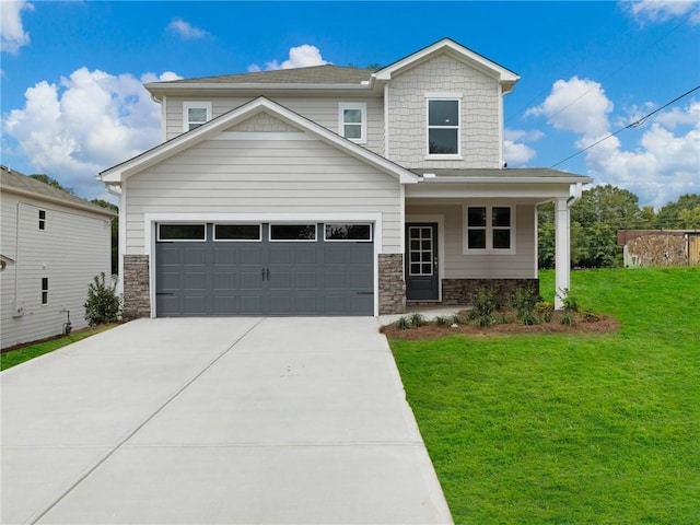 view of front of property featuring a front lawn and a garage