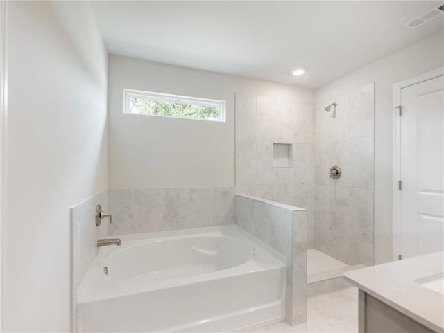 bathroom featuring plus walk in shower, tile patterned floors, and vanity