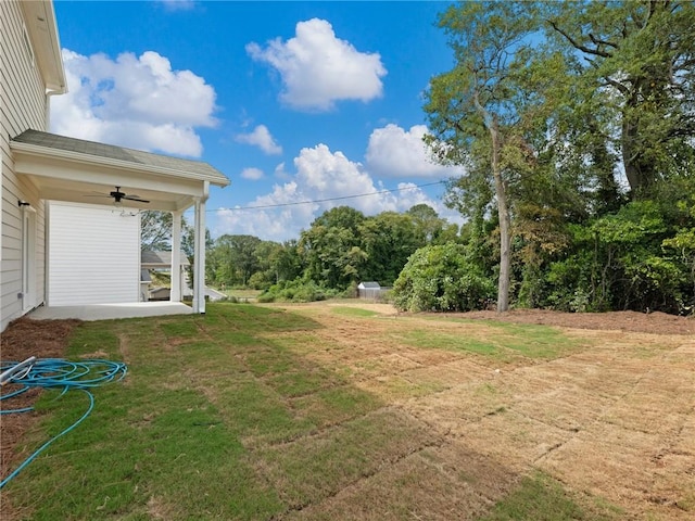 view of yard with ceiling fan and a patio area