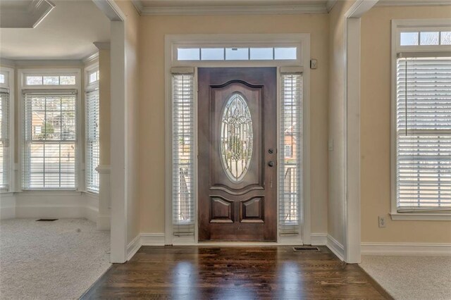 interior space featuring carpet floors, baseboards, and ornamental molding