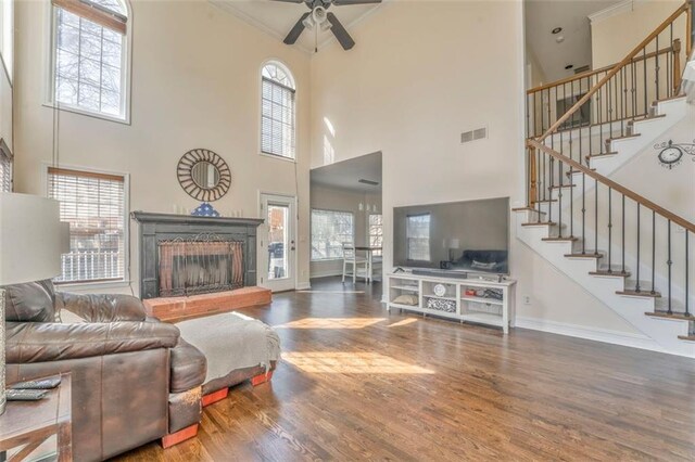 sitting room with baseboards, wood finished floors, and a healthy amount of sunlight