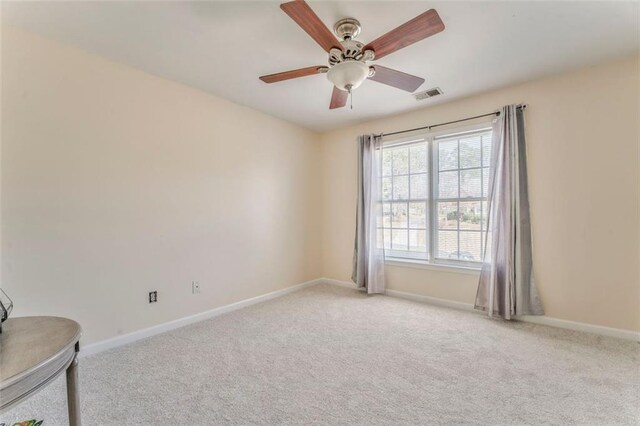 living area with a towering ceiling, a fireplace, visible vents, and wood finished floors