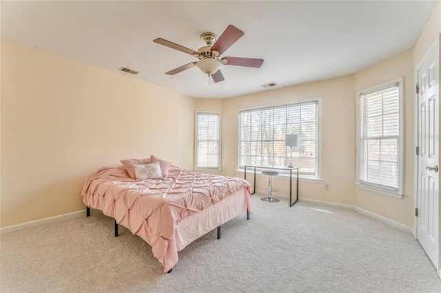 carpeted bedroom featuring visible vents, ceiling fan, and baseboards