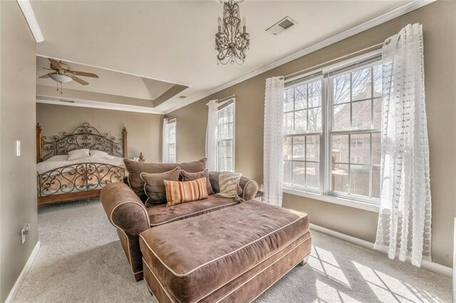 bedroom with light carpet, a tray ceiling, and crown molding