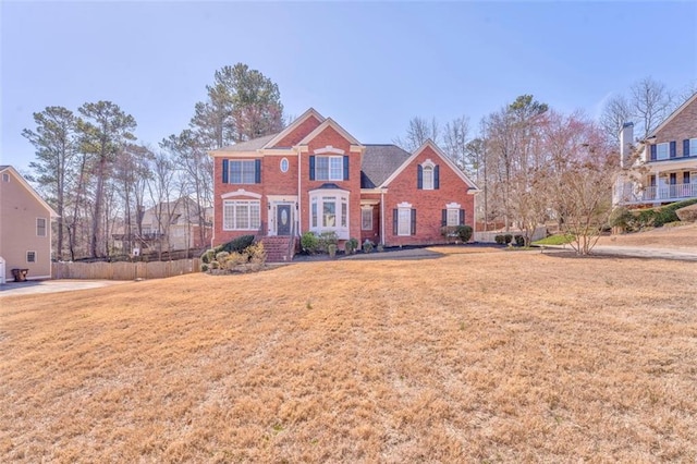 view of front of home with a front yard and brick siding