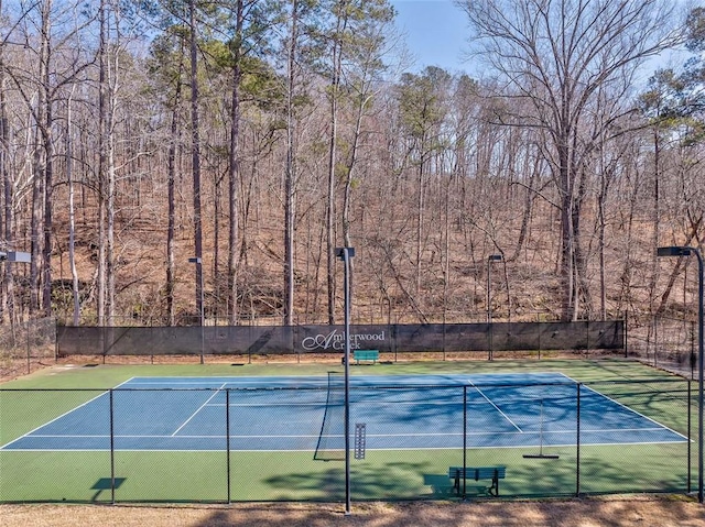 view of tennis court featuring fence