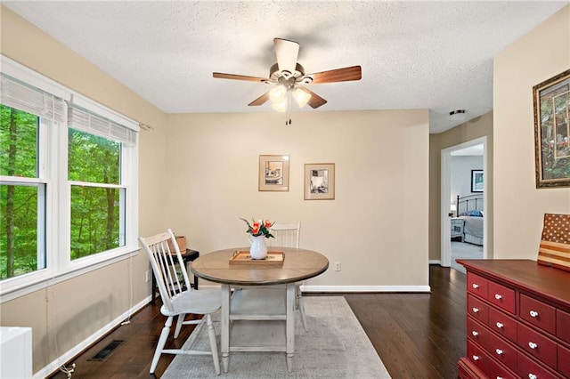 3012 Cypress Cv, Ball Ground, GA 30107 - dining area with dark wood finished floors, a ceiling fan, a textured ceiling, and baseboards