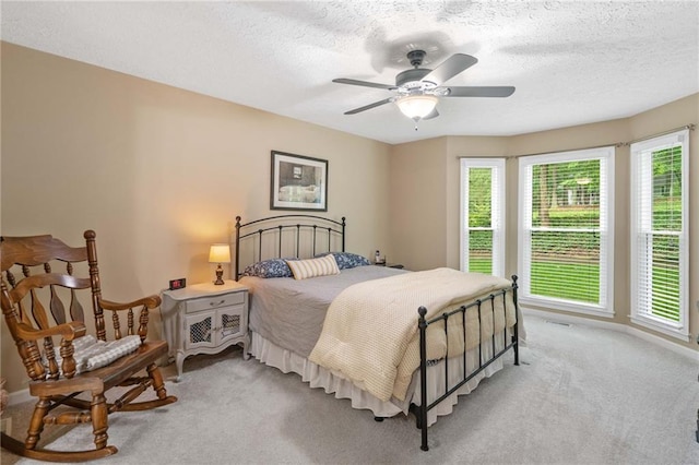 3012 Cypress Cv, Ball Ground, GA 30107 - bedroom featuring light carpet, a textured ceiling, baseboards, and a ceiling fan