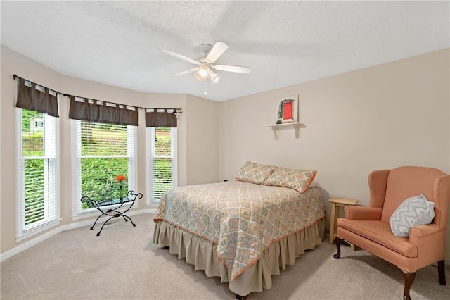 3012 Cypress Cv, Ball Ground, GA 30107 - bedroom with multiple windows, light carpet, baseboards, ceiling fan, and a textured ceiling
