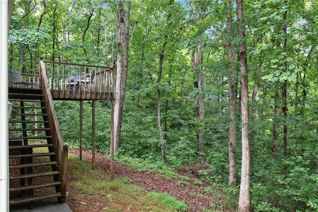 3012 Cypress Cv, Ball Ground, GA 30107 - view of yard with stairs, a deck, and a view of trees