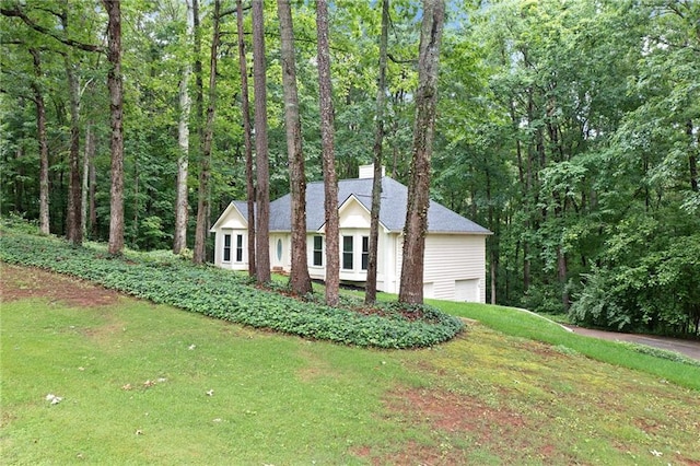 3012 Cypress Cv, Ball Ground, GA 30107 - view of front of property featuring a chimney, a front yard, a garage, and a wooded view