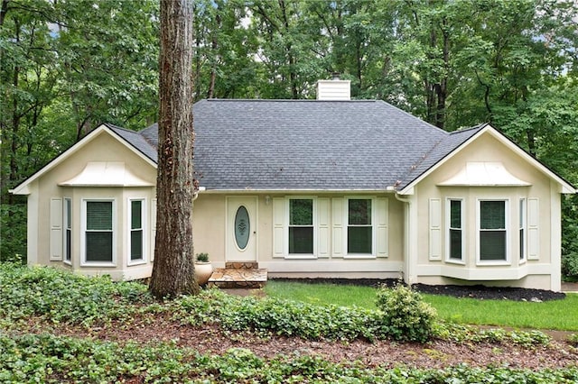 3012 Cypress Cv, Ball Ground, GA 30107 - ranch-style home featuring a chimney, a shingled roof, stucco siding, and view of wooded area