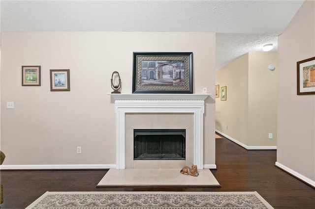 3012 Cypress Cv, Ball Ground, GA 30107 - living room with wood finished floors, baseboards, a textured ceiling, and a premium fireplace