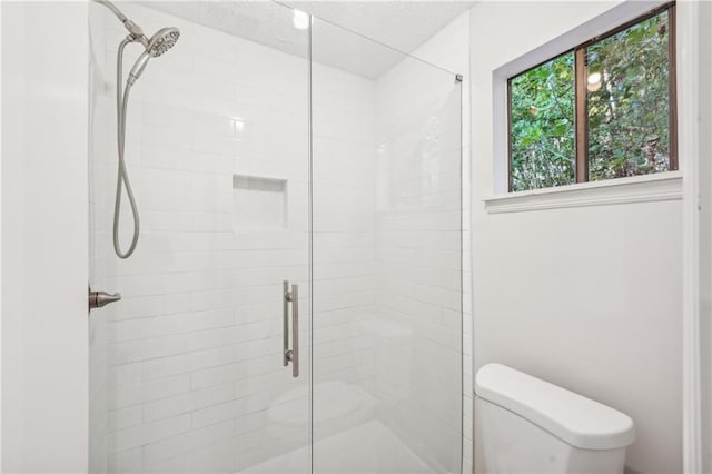 bathroom featuring toilet and an enclosed shower