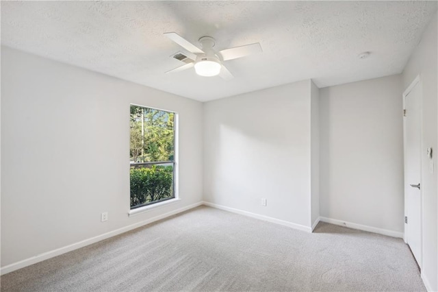 carpeted empty room featuring a textured ceiling and ceiling fan