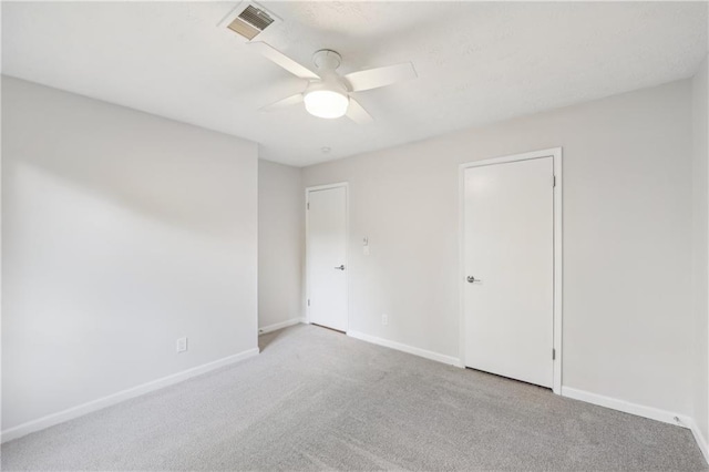 empty room with light colored carpet and ceiling fan