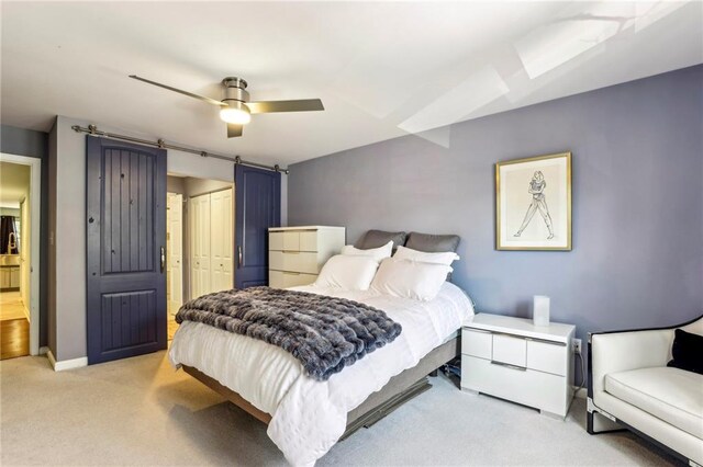 64 Devon Ln, Avondale Estates, GA 30002 - carpeted bedroom featuring a closet, ceiling fan, baseboards, and a barn door