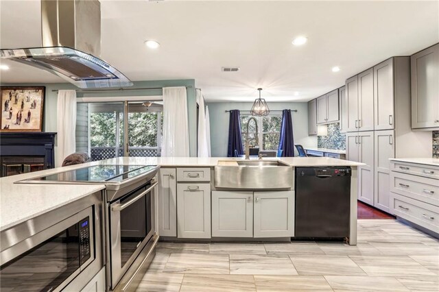 64 Devon Ln, Avondale Estates, GA 30002 - kitchen featuring appliances with stainless steel finishes, island range hood, light countertops, gray cabinets, and recessed lighting