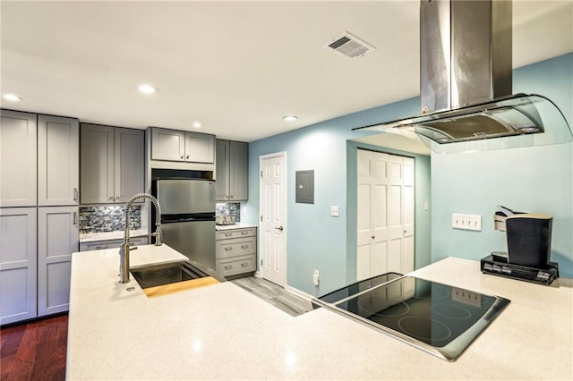 64 Devon Ln, Avondale Estates, GA 30002 - kitchen with island exhaust hood, cooktop, dark wood finished floors, a sink, and gray cabinetry