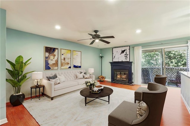 64 Devon Ln, Avondale Estates, GA 30002 - living area featuring wood finished floors, a glass covered fireplace, baseboards, a ceiling fan, and recessed lighting