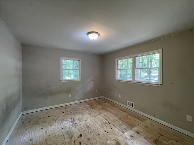 6106 Oak Hill Dr SW, Austell, GA 30168 - unfurnished room with plenty of natural light, baseboards, and wood finished floors