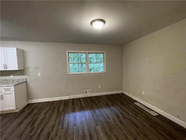 6106 Oak Hill Dr SW, Austell, GA 30168 - unfurnished dining area featuring dark wood-style floors and baseboards