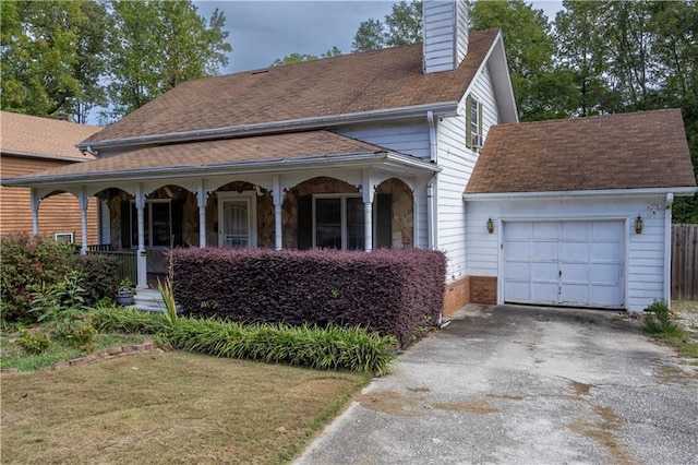 view of front of home featuring a garage, a front lawn, and covered porch