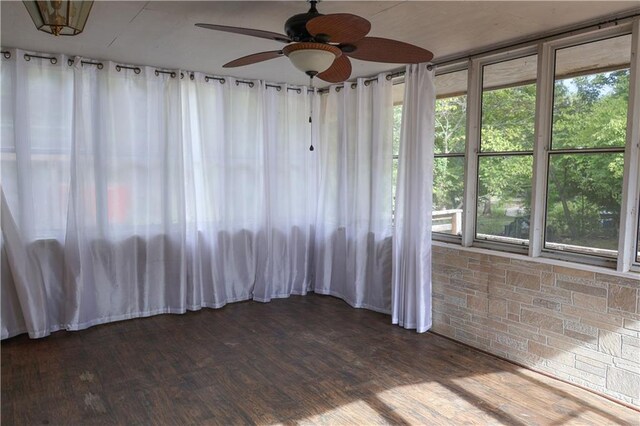 spare room featuring ceiling fan, dark hardwood / wood-style floors, and a healthy amount of sunlight