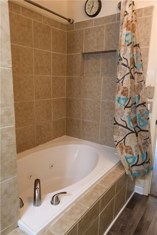 bathroom featuring shower / bath combination with curtain and hardwood / wood-style flooring