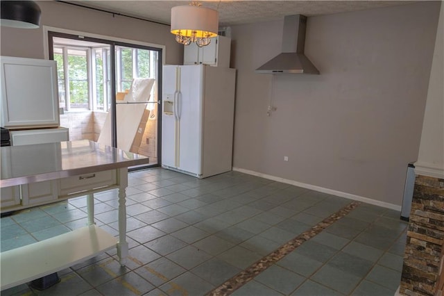 interior space with wall chimney exhaust hood, tile patterned flooring, a textured ceiling, and white refrigerator with ice dispenser