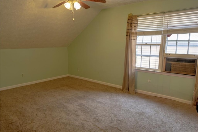 bonus room featuring vaulted ceiling, ceiling fan, carpet flooring, and a textured ceiling