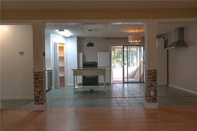 interior space with a textured ceiling, a chandelier, and light tile patterned flooring