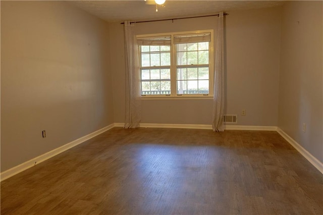 empty room with dark wood-type flooring