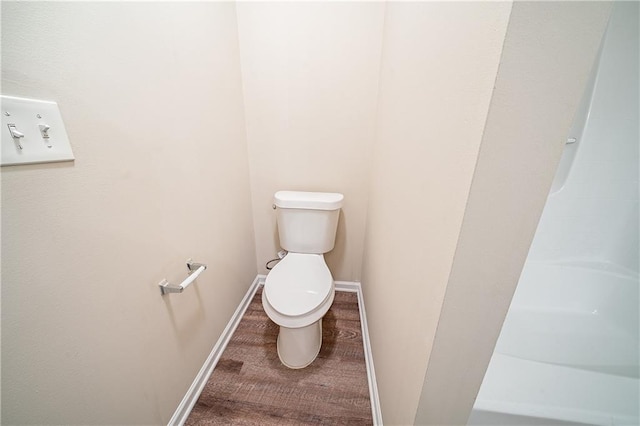 full bath with toilet, baseboards, and a shower