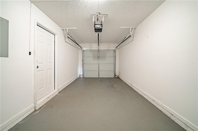 garage with a garage door opener and baseboards