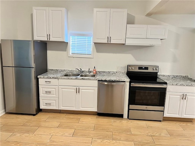 701 Cameron M Alexander Blvd NW, Atlanta, GA 30318 - kitchen with appliances with stainless steel finishes, a sink, wood finish floors, and white cabinetry
