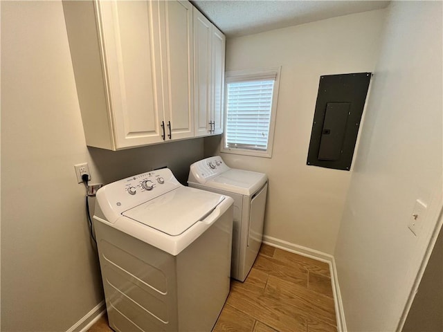 701 Cameron M Alexander Blvd NW, Atlanta, GA 30318 - washroom with electric panel, cabinet space, washer and clothes dryer, baseboards, and light wood-style floors